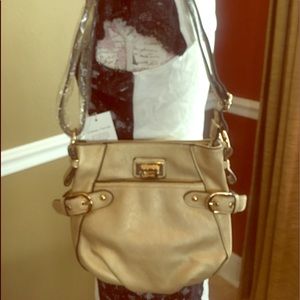 A gold Cross body purse. NWT